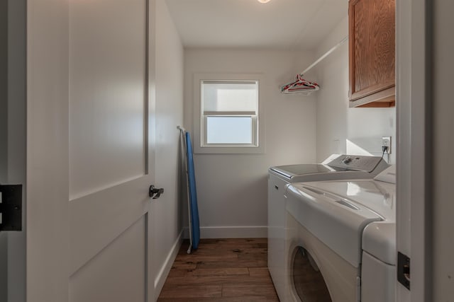 washroom featuring cabinets, independent washer and dryer, and dark wood-type flooring