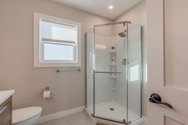 bathroom with tile patterned flooring, toilet, vanity, and walk in shower