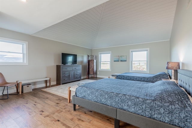 bedroom with light wood-type flooring, lofted ceiling, and wooden ceiling