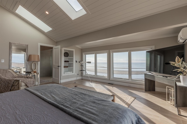 bedroom with a wall mounted air conditioner, light wood-type flooring, vaulted ceiling with skylight, and wood ceiling