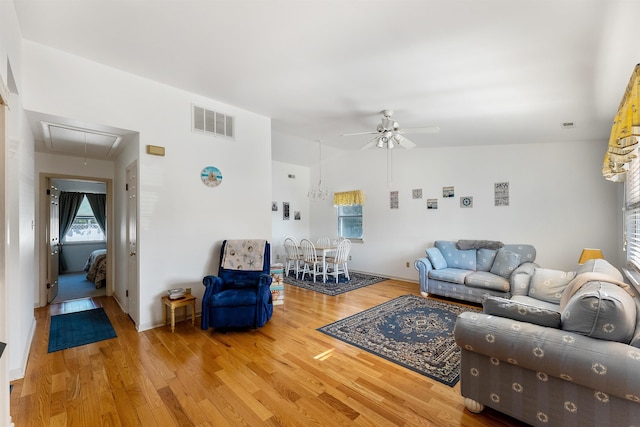 living room with hardwood / wood-style flooring and ceiling fan