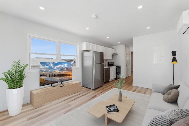 2001 Surf Ave Unit 13, North Wildwood, NJ 08260 - living area featuring light wood finished floors, recessed lighting, a wall mounted AC, and baseboards