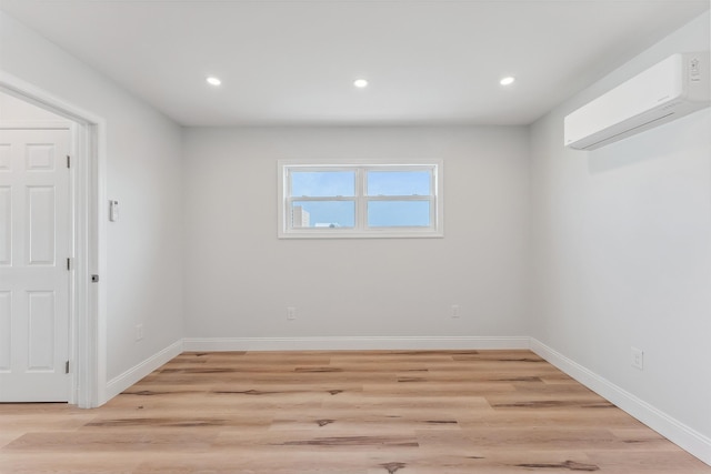 2001 Surf Ave Unit 13, North Wildwood, NJ 08260 - empty room with a wall unit AC, recessed lighting, light wood finished floors, and baseboards