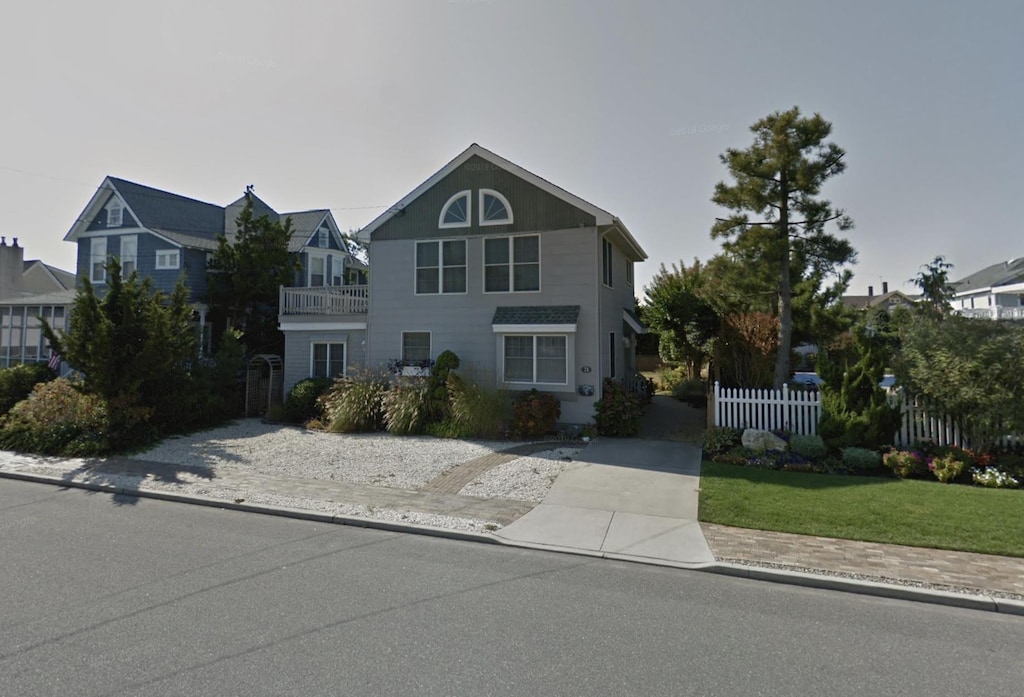 traditional home featuring fence and driveway