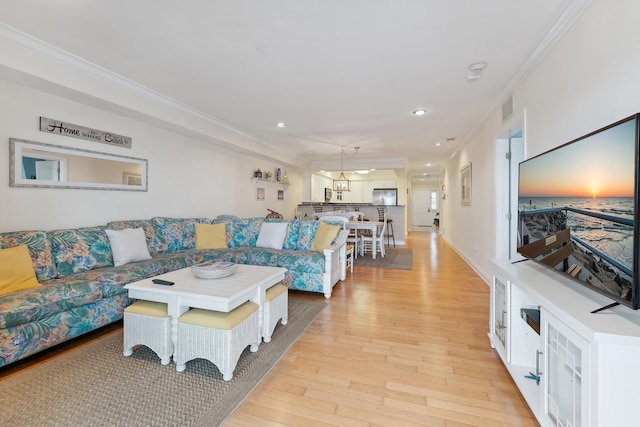 living room with crown molding and light wood-type flooring