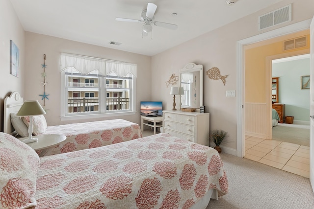 bedroom featuring ceiling fan and light carpet