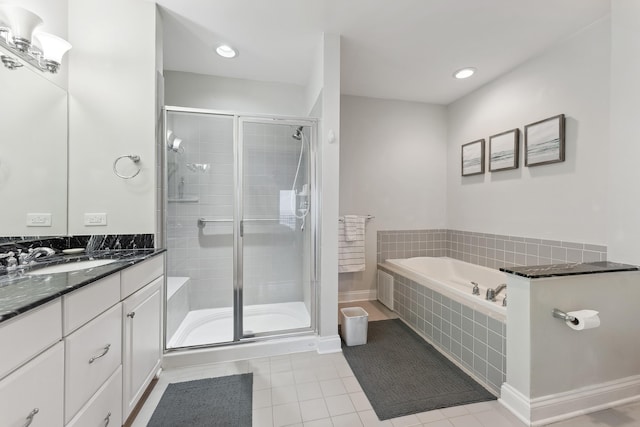 bathroom featuring vanity, tile patterned floors, and shower with separate bathtub