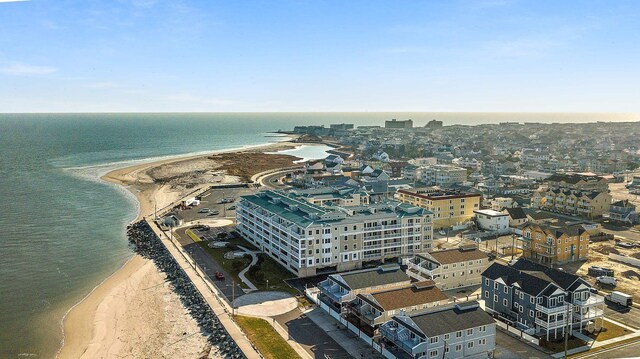 drone / aerial view featuring a water view and a beach view