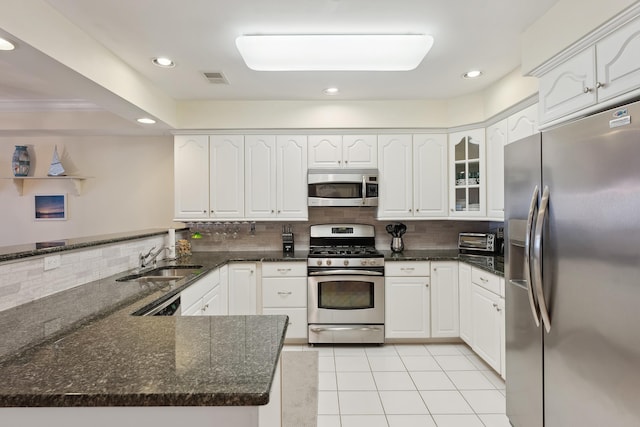 kitchen with kitchen peninsula, white cabinets, and appliances with stainless steel finishes