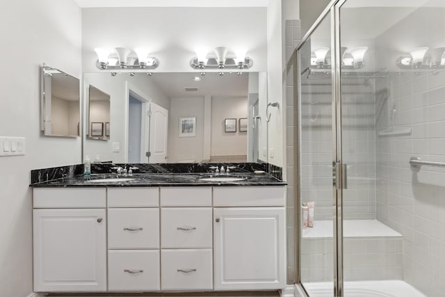 bathroom featuring vanity and an enclosed shower