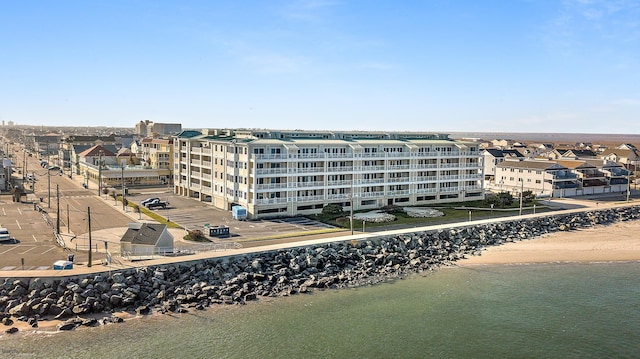 exterior space with a water view and a beach view