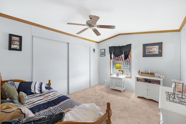 bedroom featuring carpet floors, crown molding, a closet, lofted ceiling, and ceiling fan