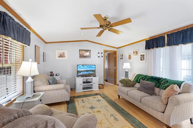 living room featuring crown molding, a ceiling fan, vaulted ceiling, and light wood finished floors