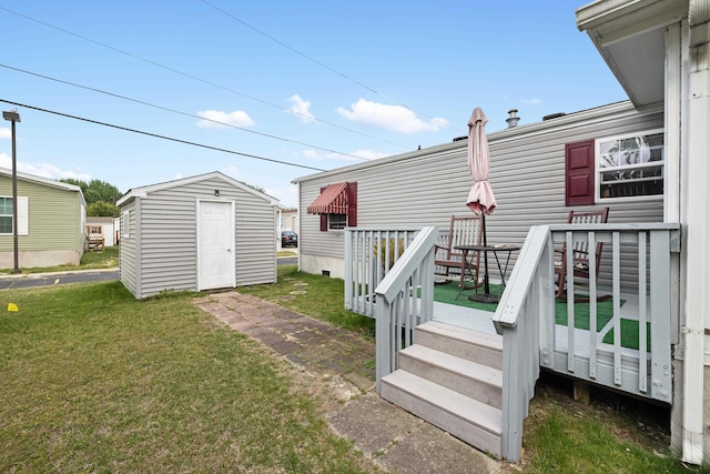 view of yard with an outdoor structure, a wooden deck, and a storage shed