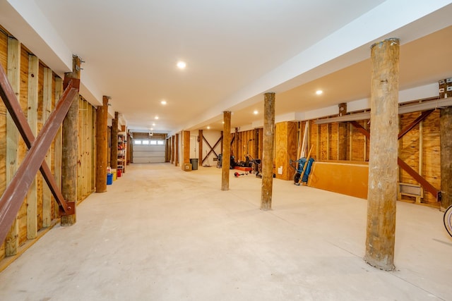 basement featuring recessed lighting and stairs