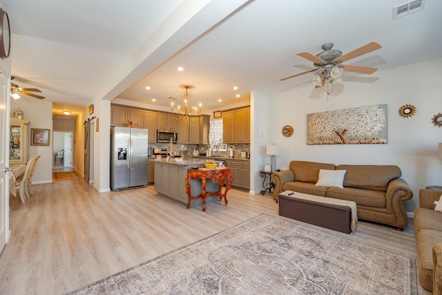 living area with ceiling fan with notable chandelier, light wood finished floors, visible vents, and recessed lighting