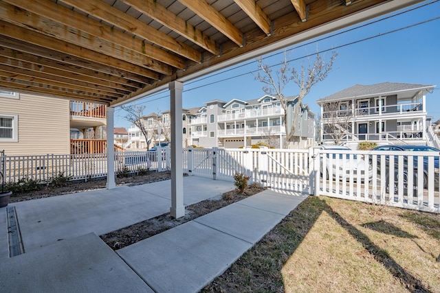 view of patio / terrace with a residential view, a gate, and fence