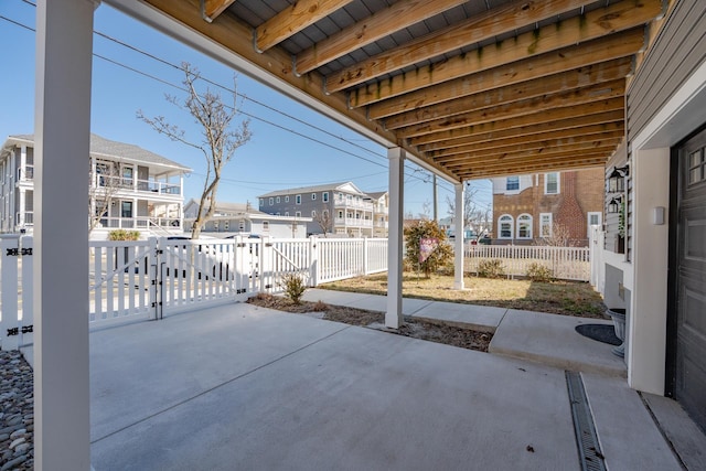 view of patio / terrace with fence and a residential view