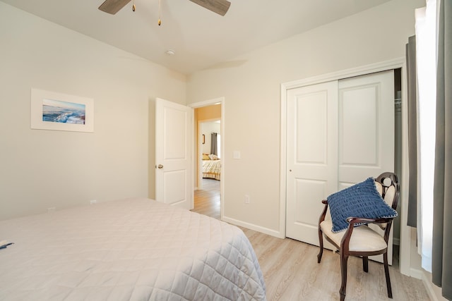 bedroom with a closet, ceiling fan, light wood-style flooring, and baseboards