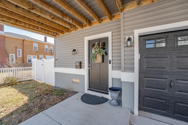 view of exterior entry with fence