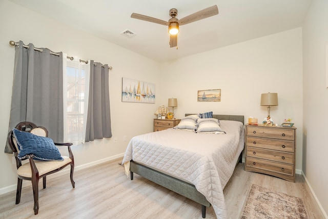 bedroom with light wood-type flooring, visible vents, ceiling fan, and baseboards