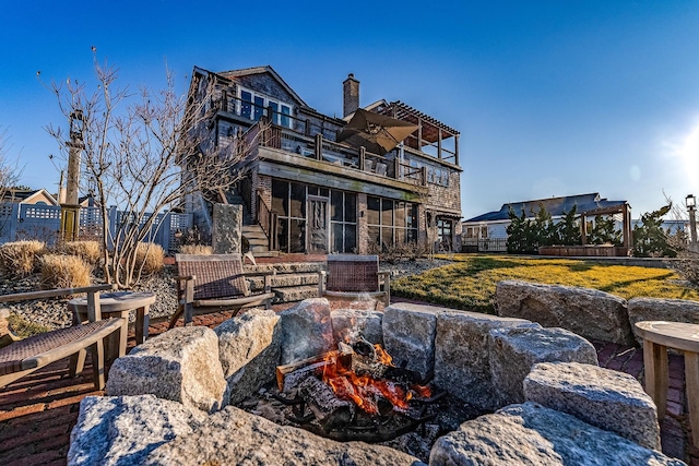 back of property featuring a balcony