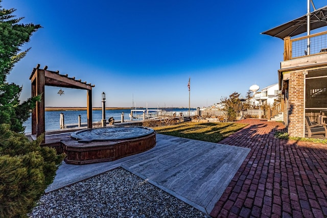 view of patio / terrace featuring a water view and a dock