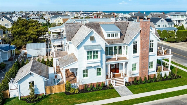 102 102nd St, Stone Harbor, NJ 08247 - view of front of home featuring a residential view, a gate, a chimney, and a balcony