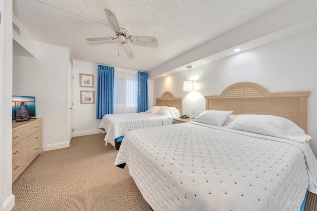 bedroom with ceiling fan, a textured ceiling, and light carpet