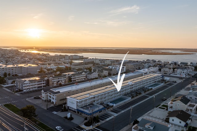 aerial view at dusk with a water view