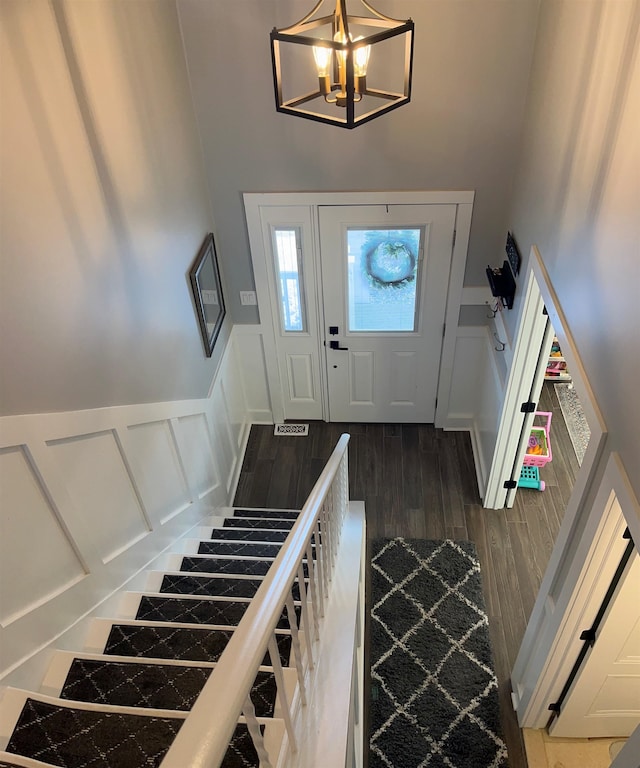 entrance foyer with a chandelier and dark wood-type flooring