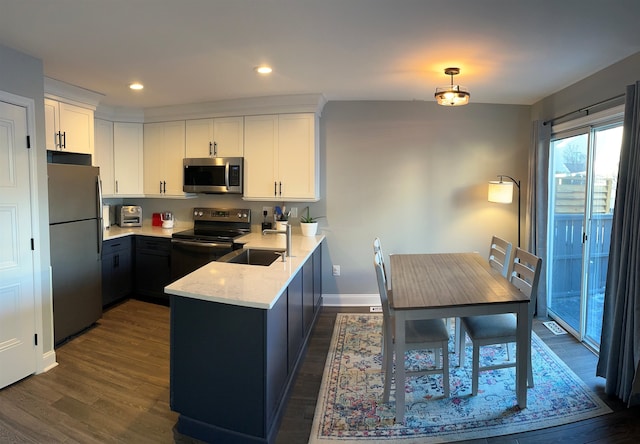 kitchen featuring sink, stainless steel appliances, white cabinetry, and light stone countertops