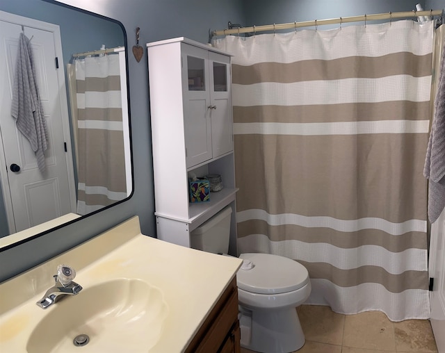 bathroom featuring tile patterned flooring, vanity, and toilet