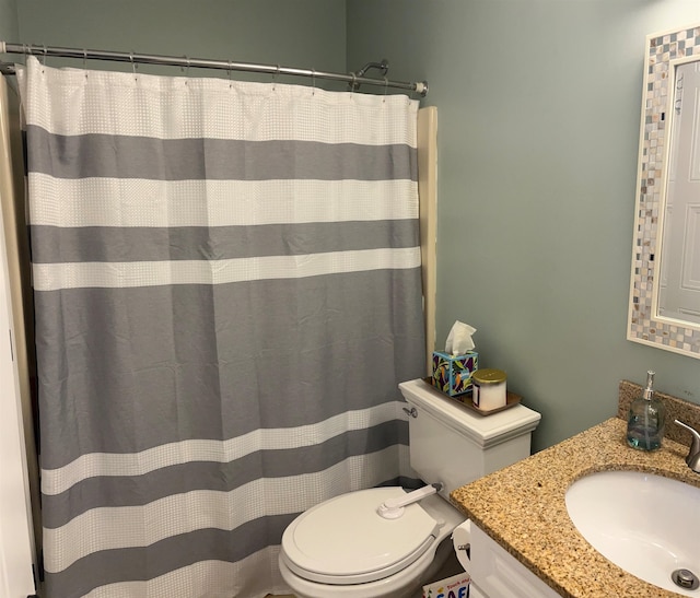 bathroom with walk in shower, vanity, and toilet