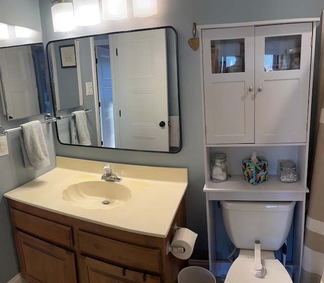 bathroom featuring vanity and toilet