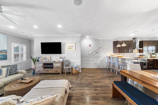 living area featuring dark wood-type flooring, recessed lighting, a ceiling fan, and a wainscoted wall