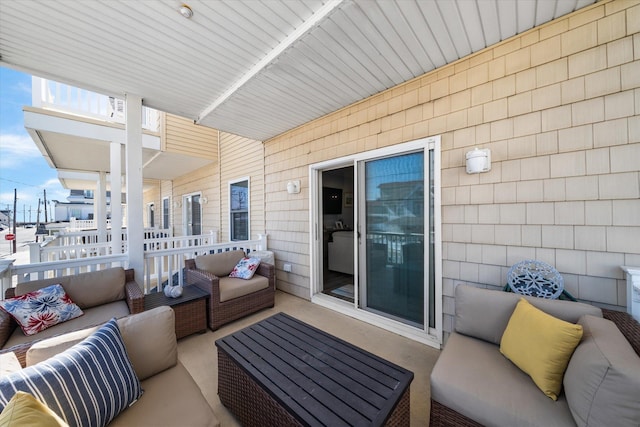 view of patio featuring an outdoor living space and a balcony
