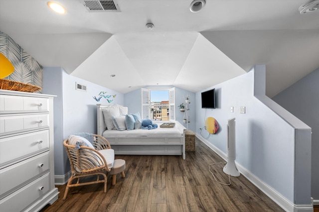 bedroom with dark wood finished floors, lofted ceiling, baseboards, and visible vents