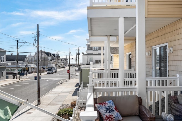 exterior space featuring street lights, a residential view, curbs, sidewalks, and traffic signs