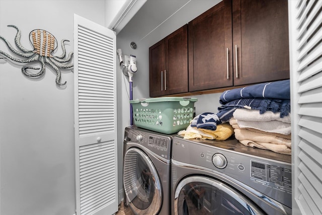washroom with cabinet space and separate washer and dryer
