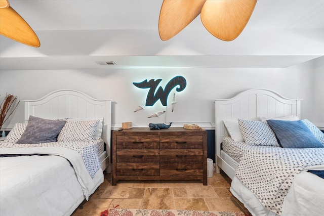 bedroom featuring visible vents and stone finish floor