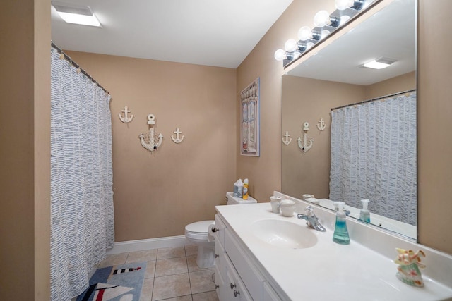 bathroom with tile patterned floors, vanity, and toilet