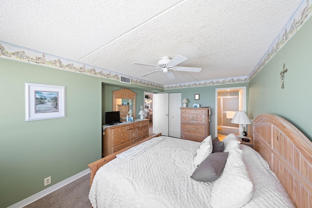 carpeted bedroom with a textured ceiling and ceiling fan