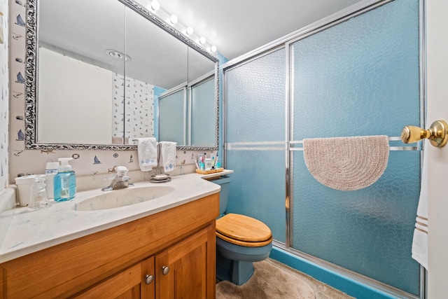 bathroom featuring toilet, vanity, and walk in shower