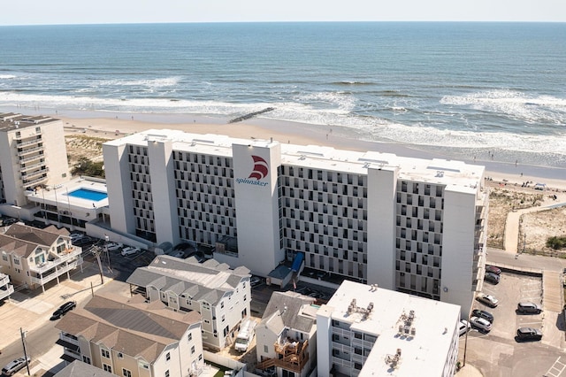 drone / aerial view featuring a water view and a beach view