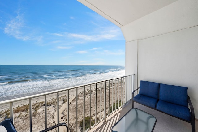 balcony featuring a water view and a beach view