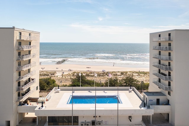 view of pool featuring a beach view and a water view