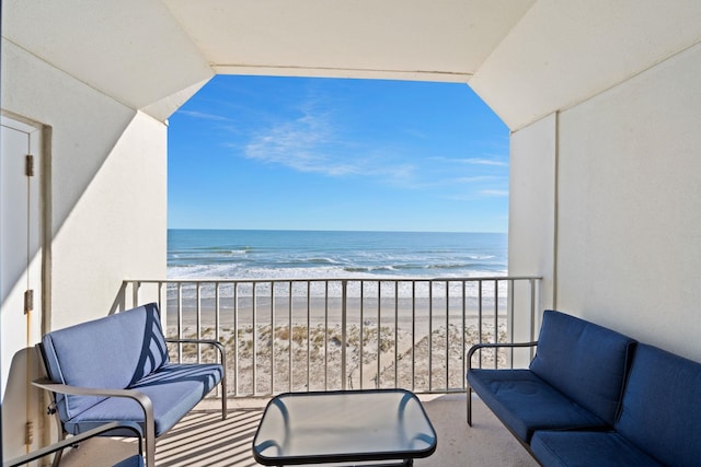 balcony featuring a water view and a view of the beach