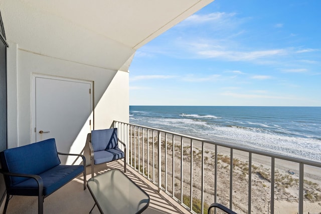 balcony featuring a beach view and a water view