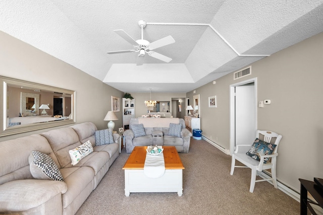 carpeted living room featuring a textured ceiling, ceiling fan with notable chandelier, vaulted ceiling, and a raised ceiling